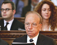 l-r: Coulson, Murdoch, Brooks, shown in a church service in 2005. Photo by Graeme Robertson/Getty