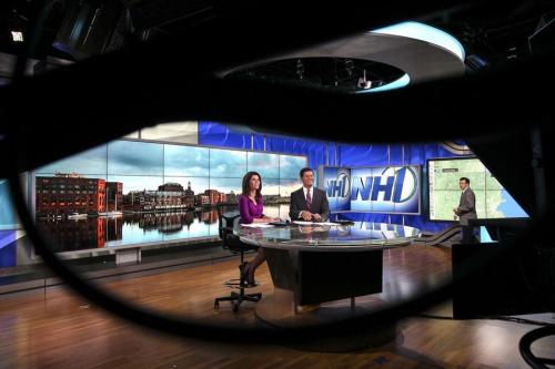 Shiny! The Globe caption says: NH1 News anchor KeKe Vencill (left), reporter/anchor Paul Mueller (center), and chief meteorologist Clayton Stiver rehearsed a news broadcast. Photo by Boston Globe