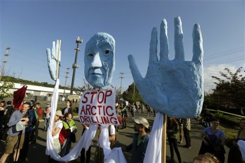 Protesters carry a large sign as they rally at the Port of Seattle, Monday, May 18, 2015, in Seattle. Demonstrators opposed to Arctic oil drilling were showing opposition to a lease agreement between Royal Dutch Shell and the Port to allow some of Shell's oil drilling equipment to be based in Seattle. (AP Photo/Ted S. Warren)